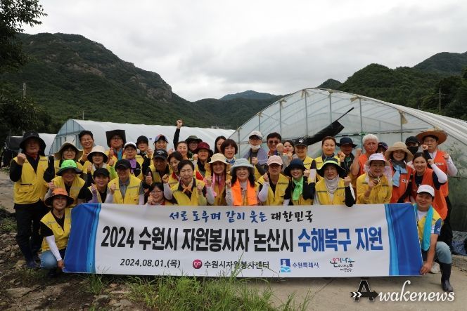 수원시자원봉사센터 재난재해봉사단은 1일 수원의 자매도시인 충남 논산시 양촌면 오산리 비 피해 비닐하우스 농가를 찾아 기념촬영을 하고 있다.